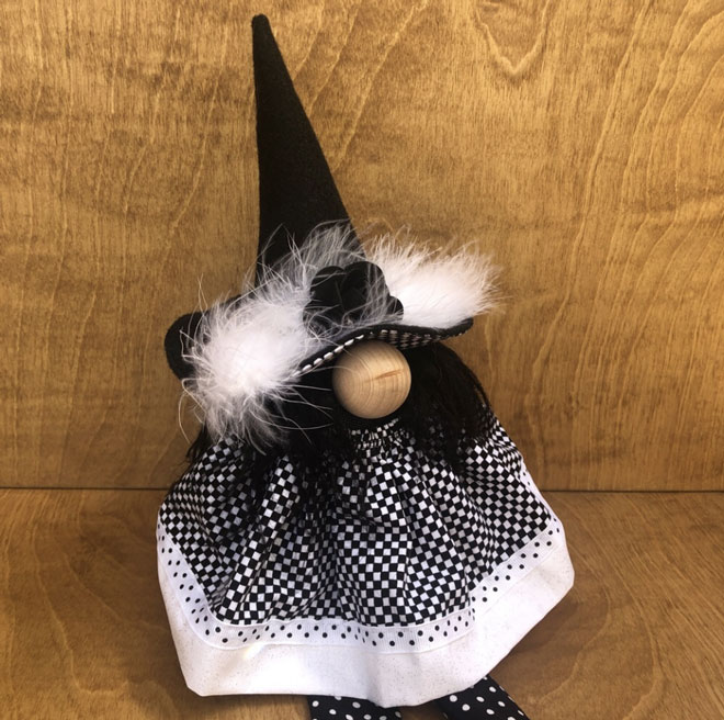 hand crafted black and white witch gnome with long legs and oversized shoes for your halloween decor.