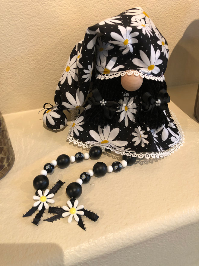 hand crafted daisy gnome with beaded legs.