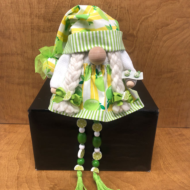 hand crafted lime tart gnome with hand crafted mini lime tarts and beaded legs.