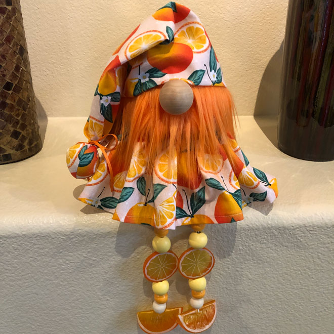 hand crafted orange blossom gnome with beaded legs.