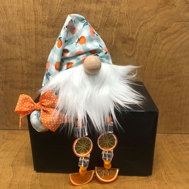 hand crafted whimsical orange gnome, oranges, ice cubes, checkered fabric and beaded legs.