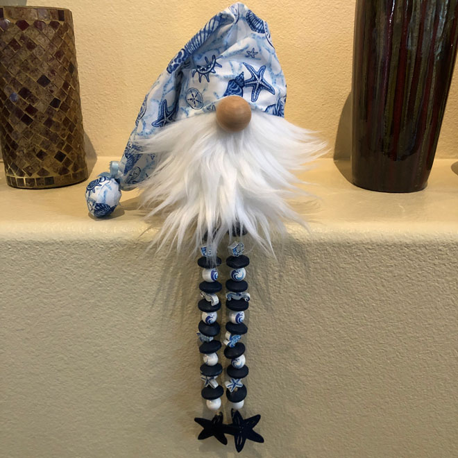 hand crafted seashell gnome with beaded legs.