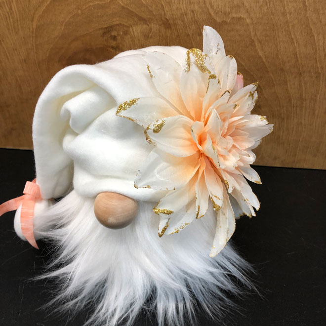 hand crafted white gnome with peach, salmon colored flower.